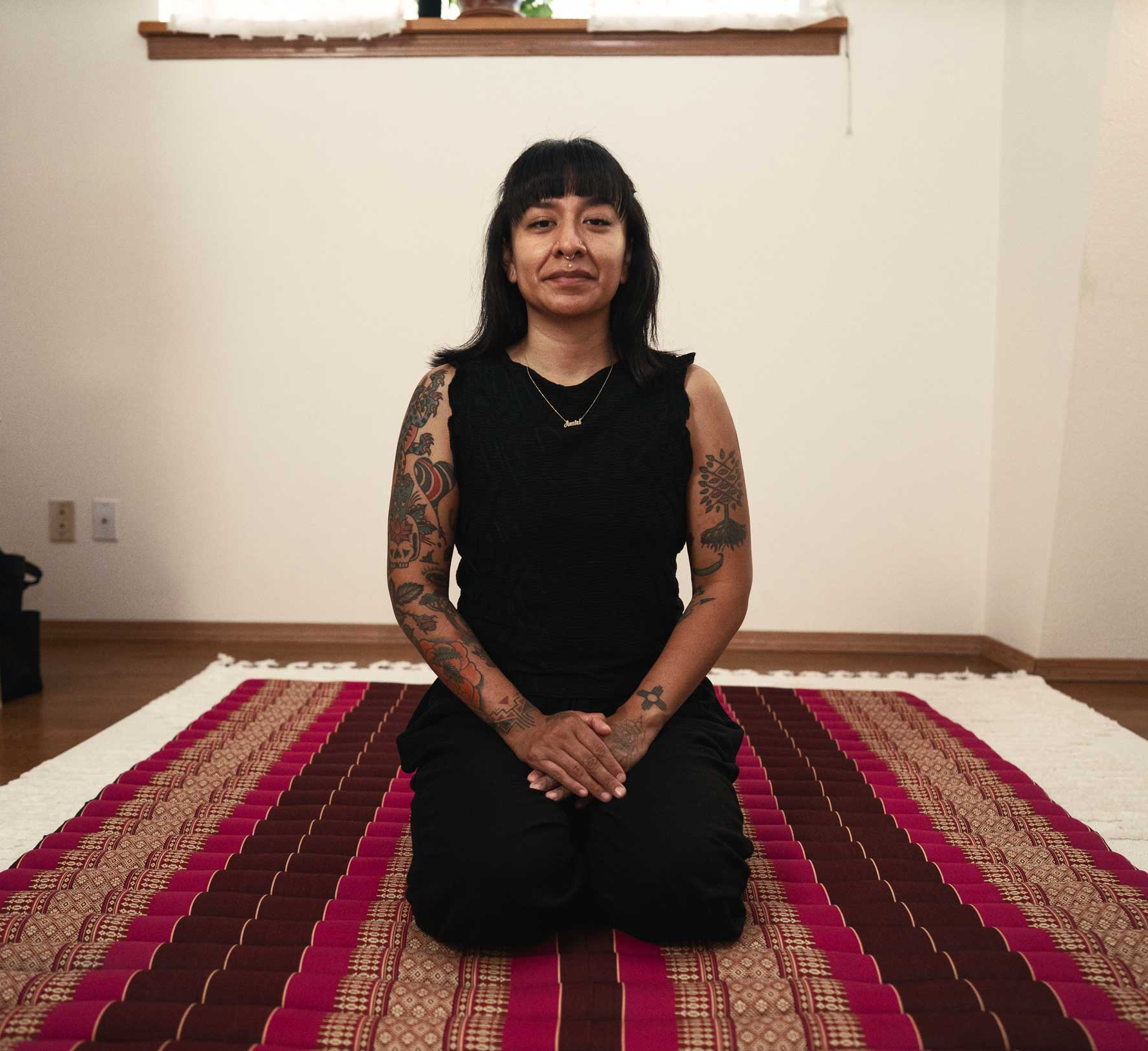 Erika sitting on a Thai mat